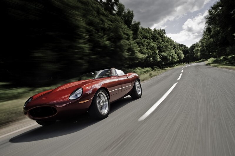 Red sports car on a country road