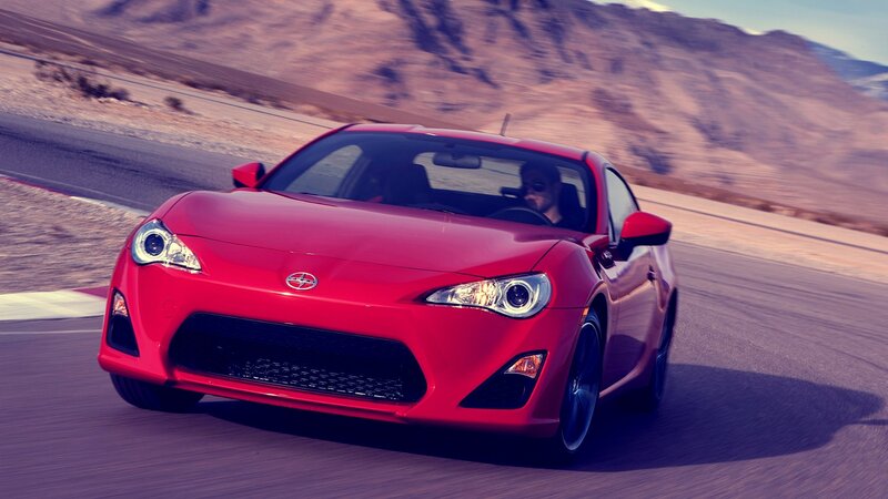 red sports car on a desert road