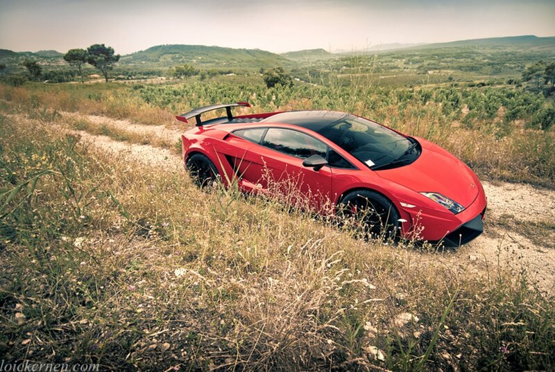 Red sports car on a dirt road