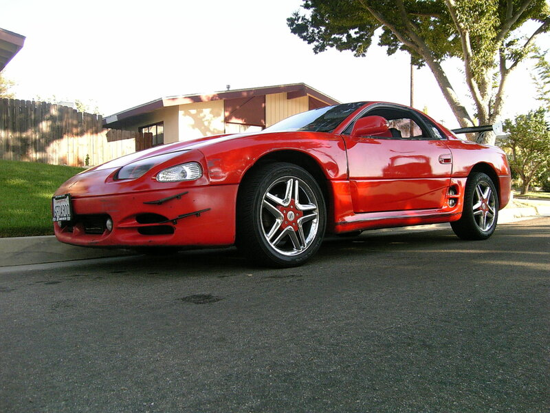 Red sports car on a driveway