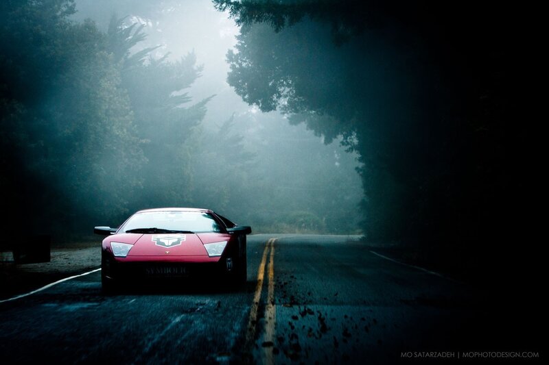 Red sports car on a foggy road