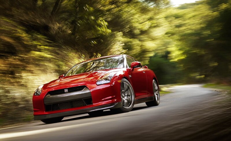 Red sports car on a forest road