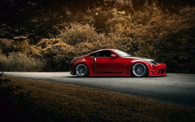 Red sports car on a forest road