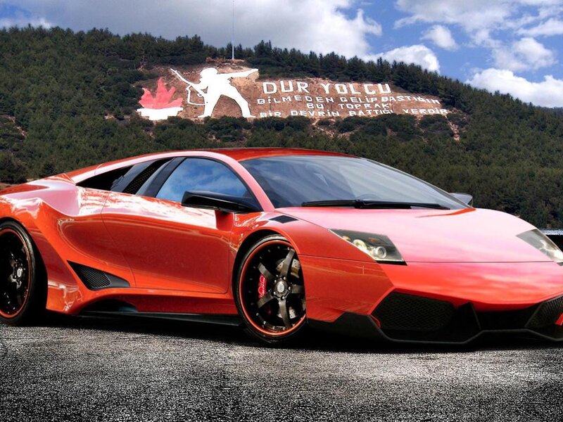 Red sports car on a mountain road