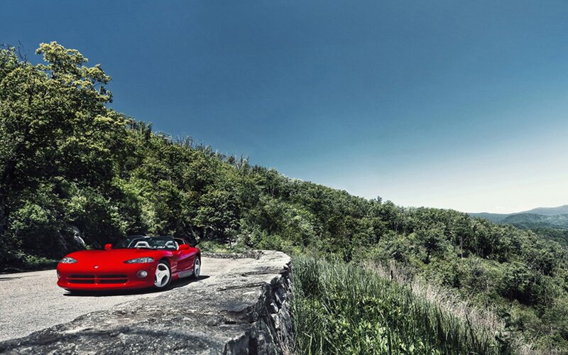 Red sports car on a mountain road