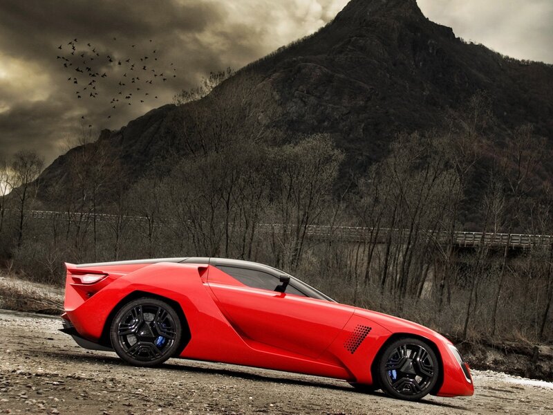 Red sports car on a mountain road