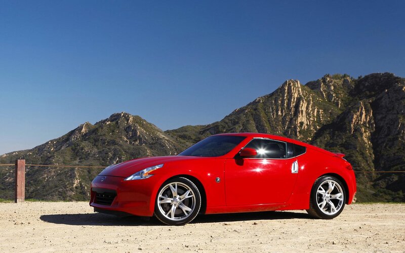 Red sports car on a mountain road