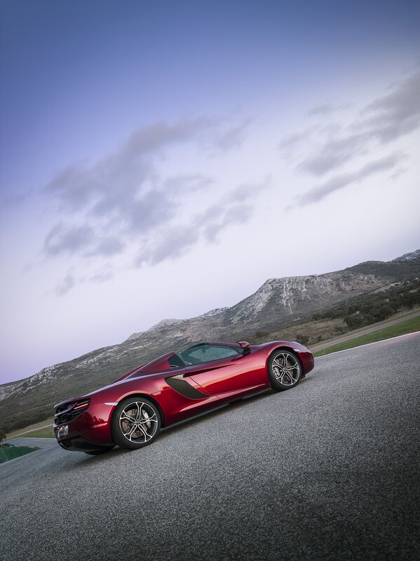 Red sports car on a mountain road