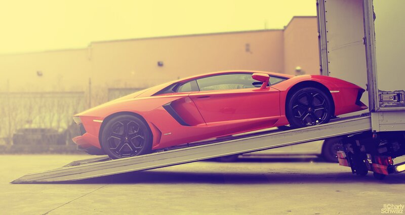 Red sports car on a ramp