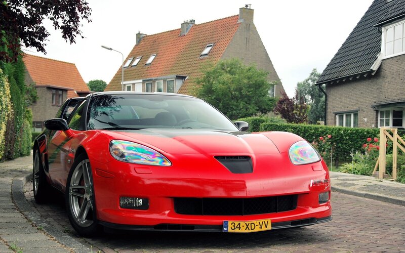 Red sports car on a residential street