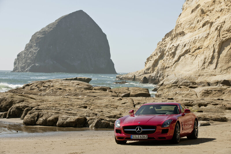 Red sports car on a rocky beach