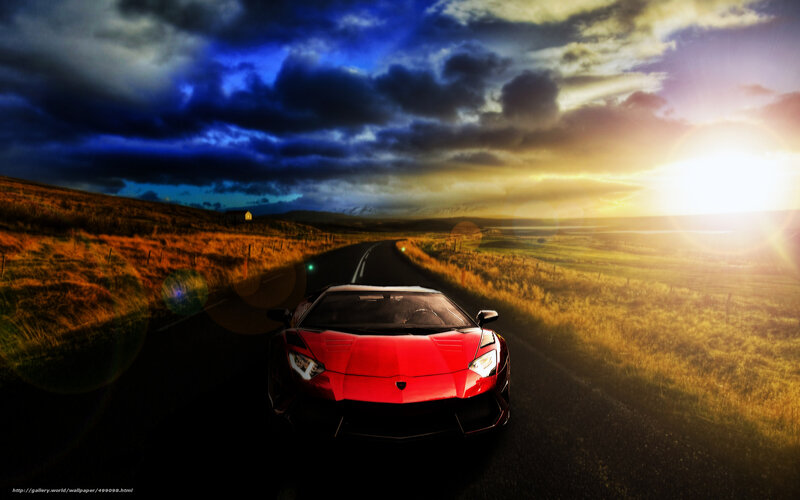 Red sports car on a scenic road