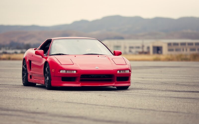 Red sports car on a tarmac