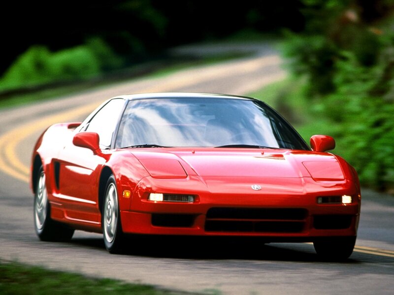 Red sports car on a winding road