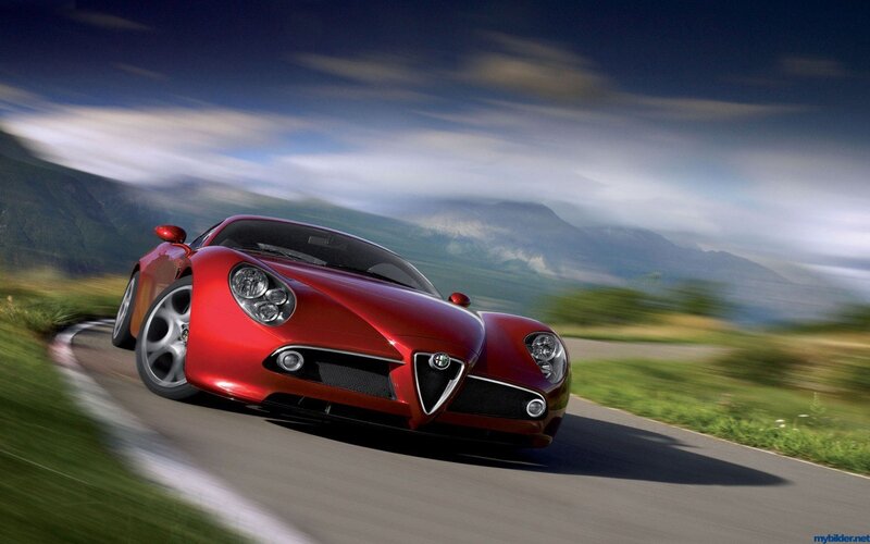 Red sports car on a winding road