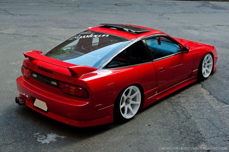 red sports car on asphalt
