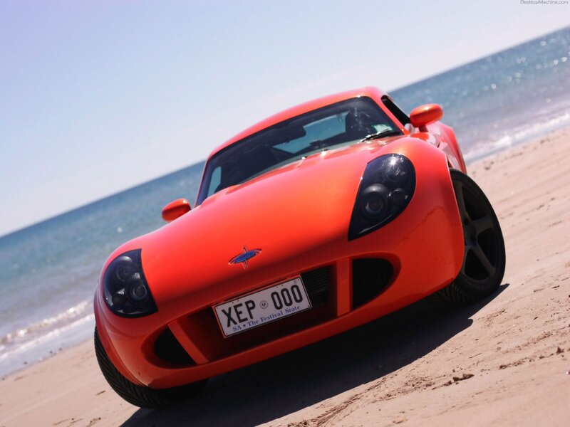 Red sports car on beach