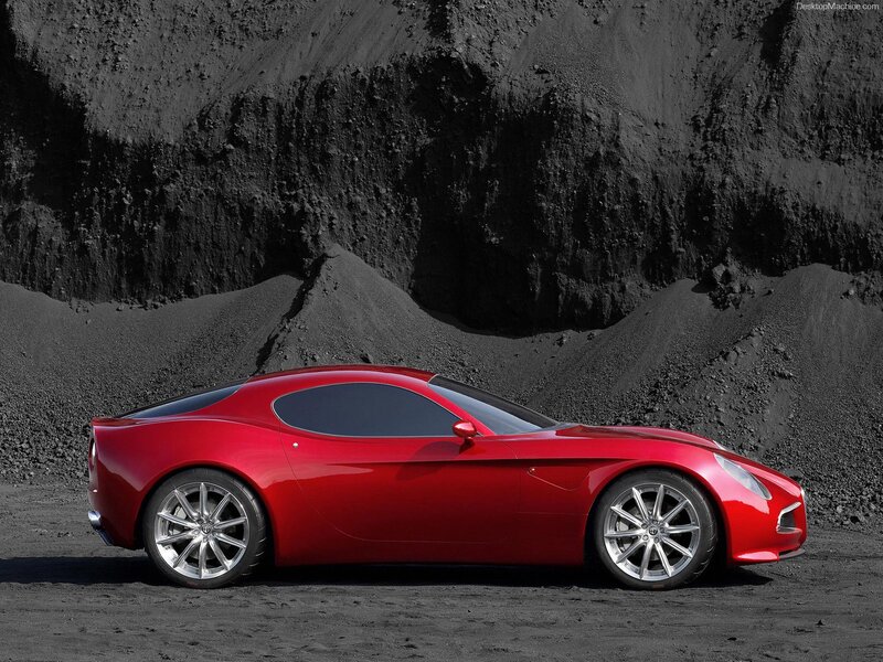 Red sports car on black sand