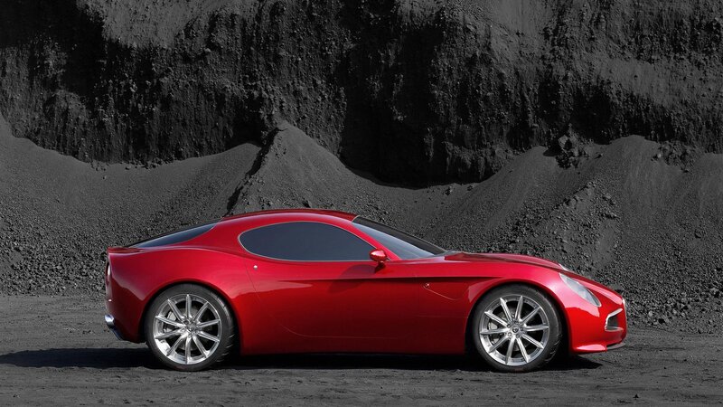 Red sports car on black sand