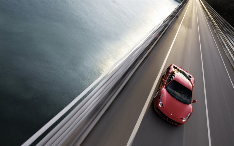 Red Sports Car on Bridge — Dynamic, Sunset