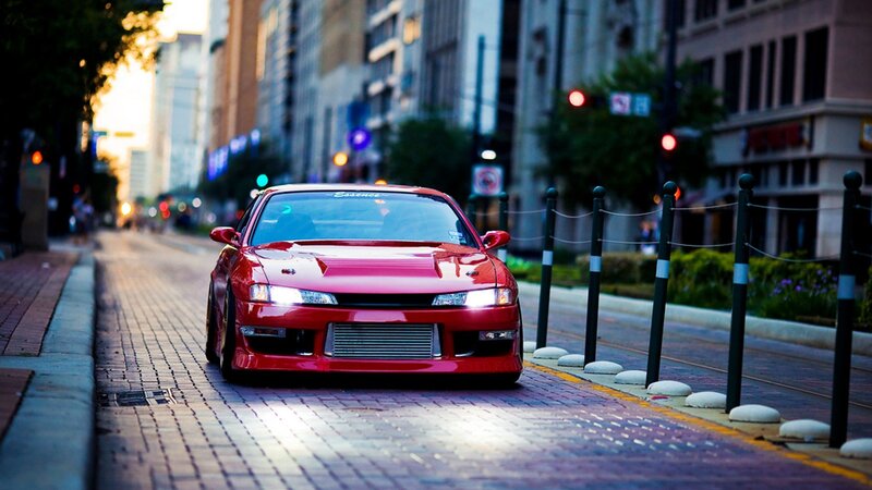 Red sports car on city street