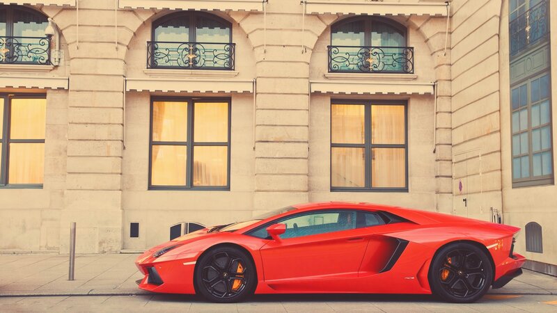 Red sports car on city street