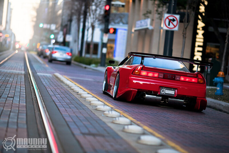Red sports car on city street