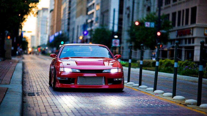 red sports car on city street