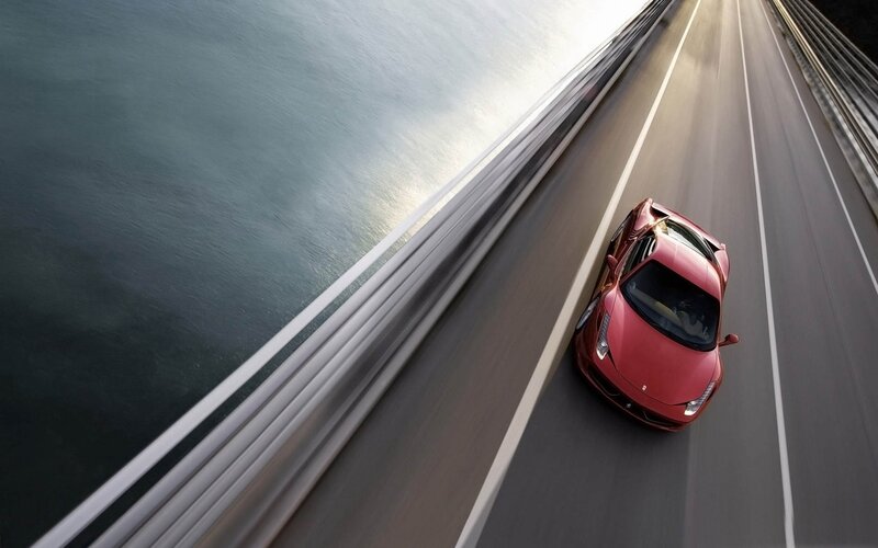 Red sports car on coastal road