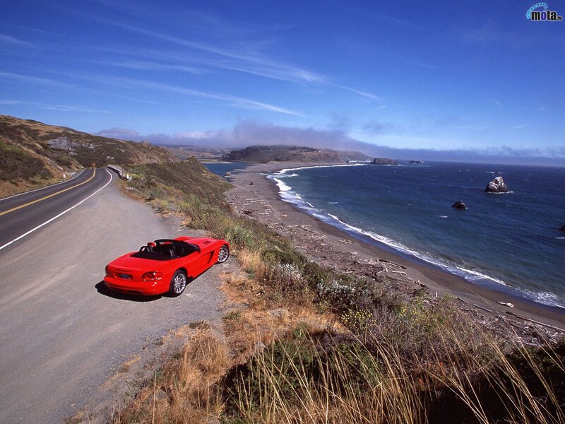 Red sports car on coastal road