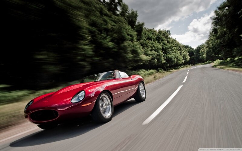 red sports car on country road