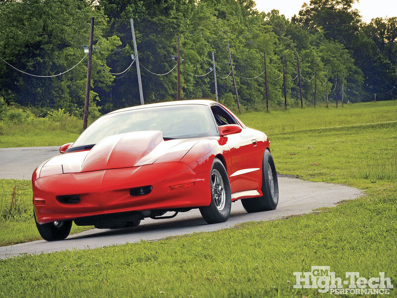 red sports car on country road