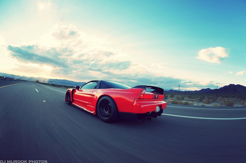 Red sports car on desert highway