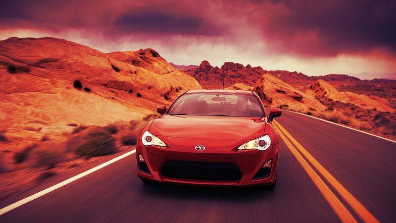 Red sports car on desert road