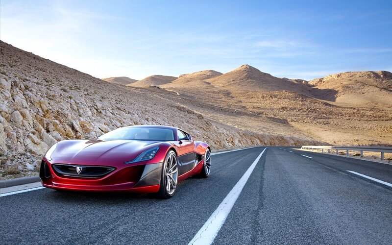 Red sports car on desert road