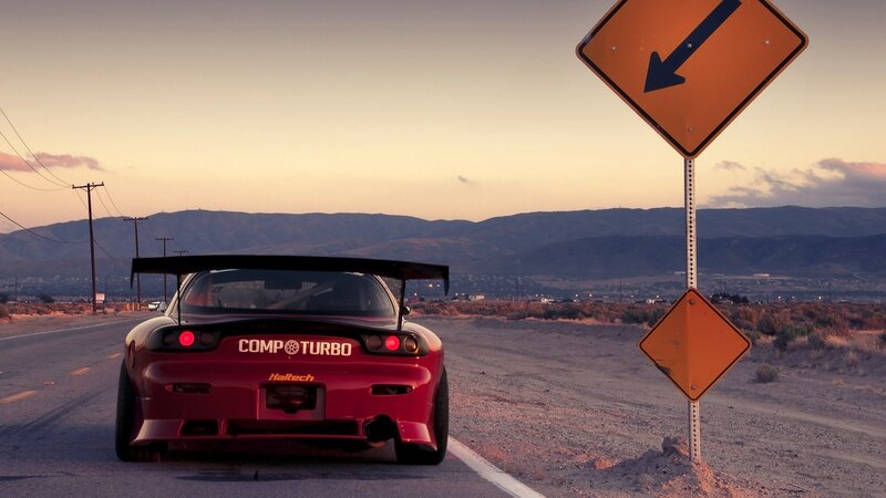 Red sports car on desert road
