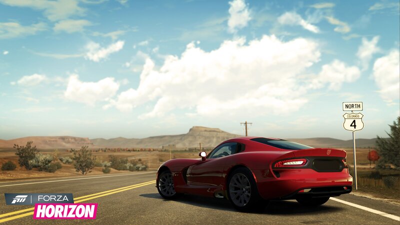 Red sports car on desert road