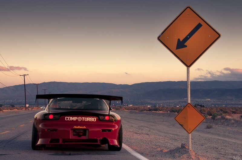 Red sports car on desert road