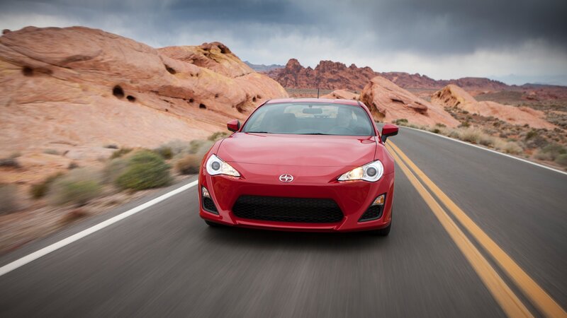 Red sports car on desert road