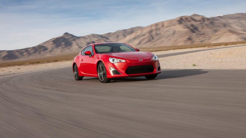 Red sports car on desert road