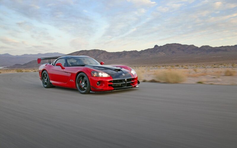 Red sports car on desert road