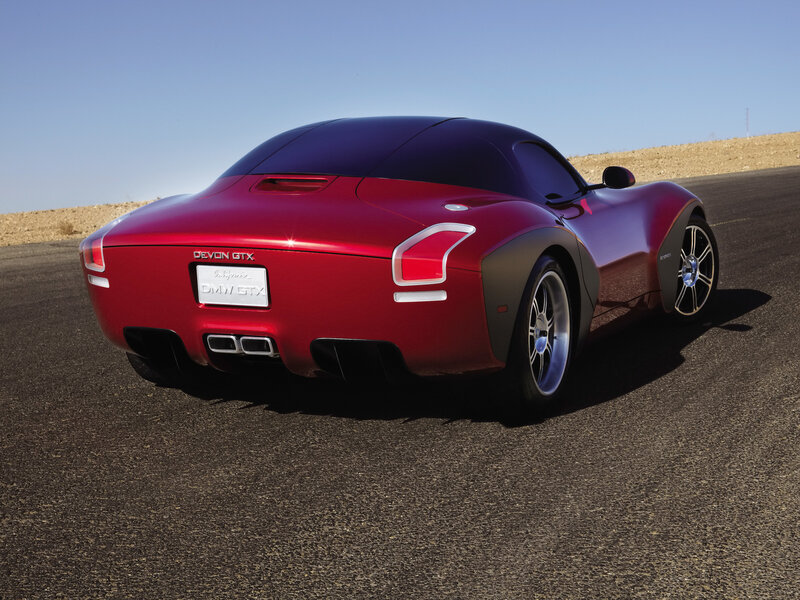 Red sports car on desert road