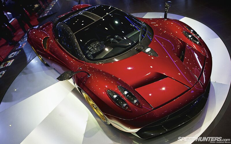 Red Sports Car on Display — Dramatic, Photograph, Show Floor