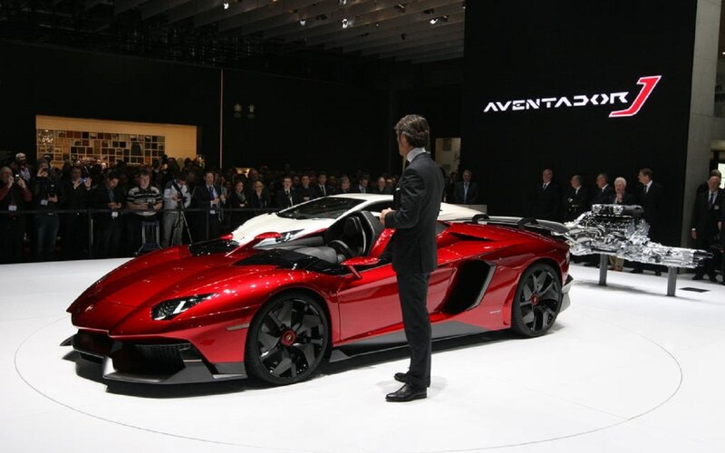 Red Sports Car on Display — Formal, Photograph, Man in Suit, Crowd