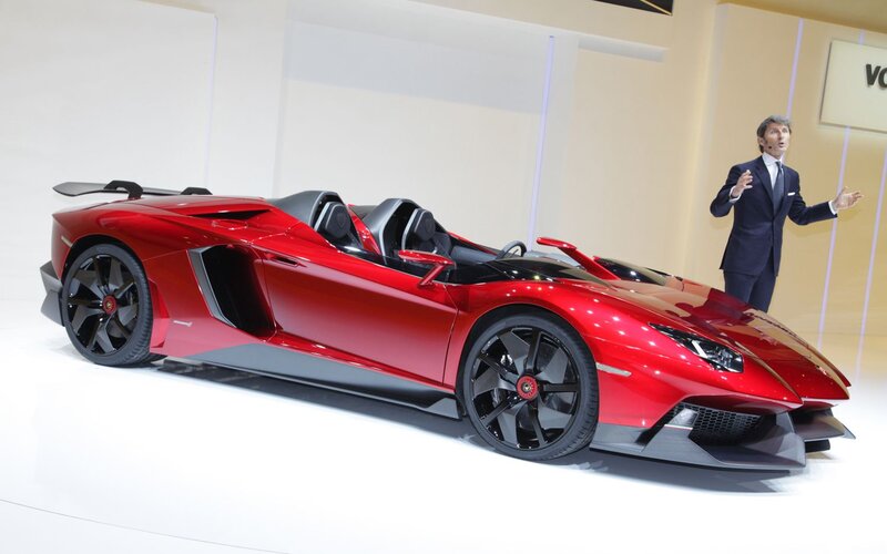 Red Sports Car on Display — Formal, Photograph, Man in Suit