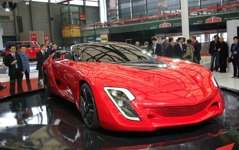 Red Sports Car on Display — Neutral, Photograph, People