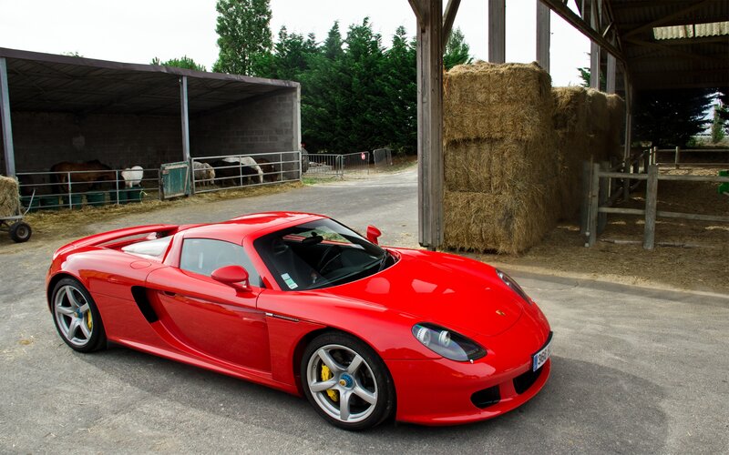 Red sports car on farm