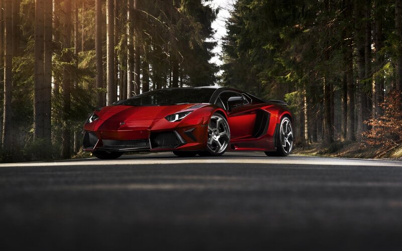 Red sports car on forest road