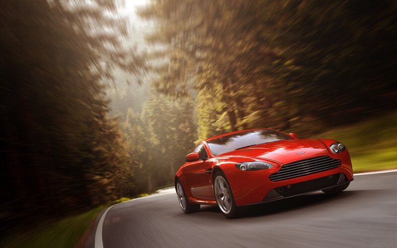 Red sports car on forest road