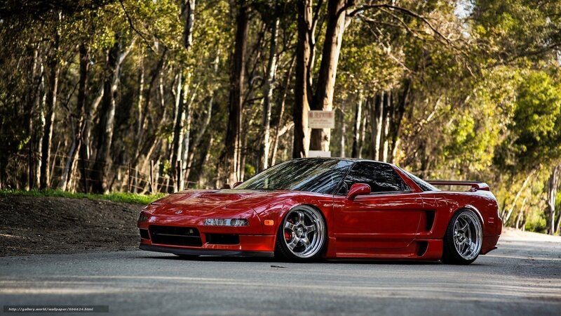 Red sports car on forest road